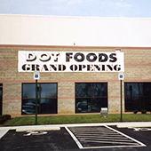 Dot Foods Grand Opening white banner on the outside of a company building